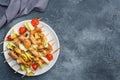 Kebab chicken, zucchini and tomatoes on skewers in a plate. Dark table Copy space Royalty Free Stock Photo