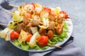 Kebab chicken, zucchini and tomatoes on skewers in a plate. Dark table Royalty Free Stock Photo
