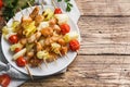 Kebab chicken, zucchini and tomatoes on skewers in a plate. Wooden table. Copy space Royalty Free Stock Photo