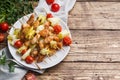 Kebab chicken, zucchini and tomatoes on skewers in a plate. Wooden table. Copy space Royalty Free Stock Photo