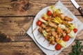 Kebab chicken, zucchini and tomatoes on skewers in a plate. Wooden table. Copy space Royalty Free Stock Photo