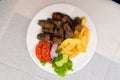 Kebab with french fries and salad, Balkan plate