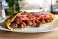 Delicious Serbian beef kebab sandwich in pita bread with fresh salad ingredients