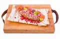 Kebab, meat on a skewer, pita bread, side dish of onions and tomatoes, pomegranate seeds and sauce on a wooden board on a white Royalty Free Stock Photo