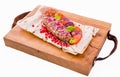 Kebab, meat on a skewer, pita bread, side dish of onions and tomatoes, pomegranate seeds and sauce on a wooden board on a white Royalty Free Stock Photo