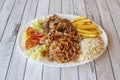 Kebab menu tray of mixed meat with lamb and chopped chicken with a garnish of French fries and white rice Royalty Free Stock Photo