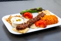 Kebab with rice and vegetables is on a plate Royalty Free Stock Photo