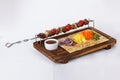 Kebab skewers of meat on a stick board