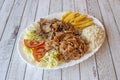 Kebab tray with mixed roast chicken and lamb meat garnished with white rice, French fries and lettuce Royalty Free Stock Photo