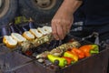 Kebabs with vegetables are cooked on a charcoal barbecue grill. Royalty Free Stock Photo
