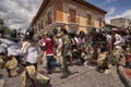 Kechwa men running on the street in Ecuador