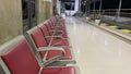 Rows of passenger seats using red seats on the Kediri station platform