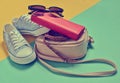 Keds, sunglasses, belt, purse, bag on a blue yellow Royalty Free Stock Photo