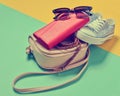 Keds, sunglasses, belt, purse, bag on a blue yellow Royalty Free Stock Photo