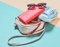 Keds, sunglasses, belt, purse, bag on a blue yellow pastel background. Women& x27;s accessories. Trend of minimalism. Royalty Free Stock Photo