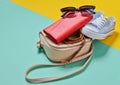 Keds, sunglasses, belt, purse, bag on a blue yellow pastel background. Women& x27;s accessories. Trend of minimalism Royalty Free Stock Photo