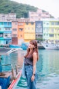 Keelung, Taiwan - October 10 2023 View of colorful Zhengbin Fishing Port in Keelung, woman traveler visiting in Taiwan.