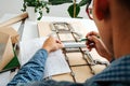 Keen box designer working on a blueprint, taking measures with a ruler Royalty Free Stock Photo