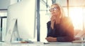 Keen business intuition. a thoughtful businesswoman working at her desk in a modern office.