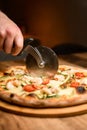 Pizza precision. Chef slices with special knife for enjoyment. Royalty Free Stock Photo