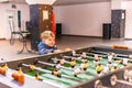 A keen and surprised boy plays table football Royalty Free Stock Photo