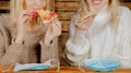 Keep calm and bon appetit! Young bold beautiful women eating pizza without medicine respirator mask. Selective focus on mask