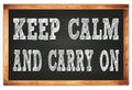 KEEP CALM AND CARRY ON words on black wooden frame school blackboard Royalty Free Stock Photo