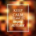 Keep calm and enjoy autumn phrase on orange blur