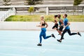 Keep calm and get fit. Full length shot of a diverse group of athletes racing each other during an outdoor track and