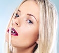 Keep calm and put on your lipstick. Closeup studio shot of a young blonde woman with vivid red lipstick against a gray Royalty Free Stock Photo