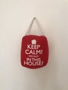 Keep Calm Seriously In This House Sign Hanging On A Wall