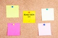 Keep calm and... on a sticky note on cork board Royalty Free Stock Photo
