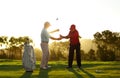 Keep the club level right through your swing. A male golfer receiving help from his caddy on the golf course. Royalty Free Stock Photo