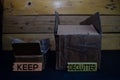 Keep and Declutter write on a sticky note between storage box isolated on wooden background