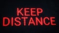 Keep distance warning banner. Red pixel text on old dusty screen