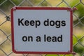 Keep Dogs on a Lead sign on a farmland gate Royalty Free Stock Photo