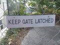 Keep gate latched sign on metal fence Royalty Free Stock Photo