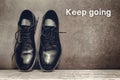 Keep going on brown board and work shoes on wooden floor