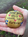 keep going painted stone portrait in hand Royalty Free Stock Photo