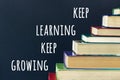 Keep learning Keep growing text and stack steps stairs of old books on background black chalkboard Concept education and way road