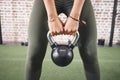 Keep in mind that your body is your slave, it works for you. a sporty young woman working out with a kettlebell at the