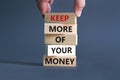 Keep more of your money symbol. Concept words Keep more of your money on wooden block. Beautiful grey table grey background.