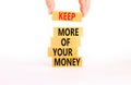 Keep more of your money symbol. Concept words Keep more of your money on wooden block. Beautiful white table white background.