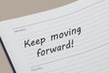Keep moving forward diary reminder appointment open on desk