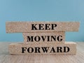 Keep moving forward symbol. Concept words Keep moving forward on blocks on beautiful wooden table blue background Royalty Free Stock Photo