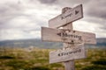 keep moving forward text engraved on old wooden signpost outdoors in nature