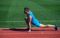 Keep moving. sportsman relax. athlete train his flexibility. be flexible. man doing stretching exercise on stadium