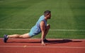 keep moving. sportsman relax. athlete train his flexibility. be flexible. man doing stretching exercise on stadium