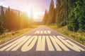 Keep moving text written on road in the mountains