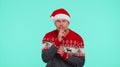 Man wears red Christmas sweater presses index finger to lips makes silence gesture sign, secret Royalty Free Stock Photo